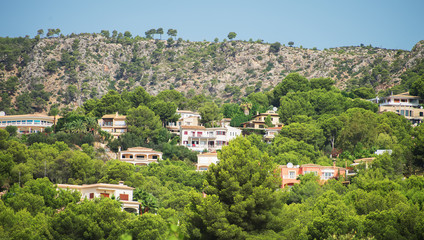 Fototapeta na wymiar Houses in the green mountain hills.