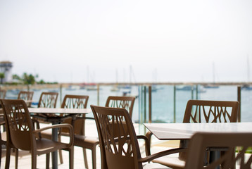 Empty outdoor street cafe by the sea.