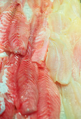 Sliced pieces of different fish on the market.