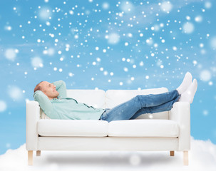 smiling man lying on sofa