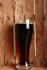 Dark ale in wooden crate