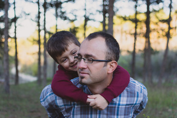 Fototapeta premium Father and son at autumn walk