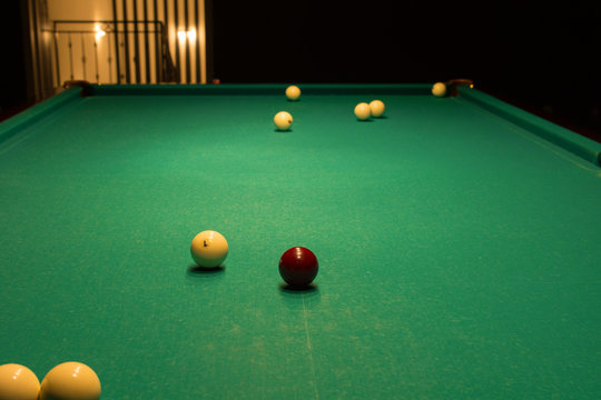 Billiard Balls Scattered on Pool Table