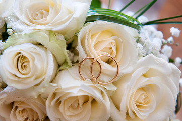 Wedding rings on a bouquet of roses