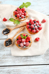 Sweet cakes with berries on table close-up