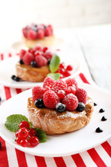 Sweet cakes with berries on table close-up