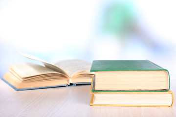 Books on wooden table on natural background