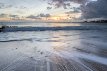 Fototapeta na wymiar Seascape with sunrise in Swanage bay