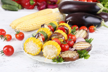 Sliced vegetables on picks on plate on table close-up