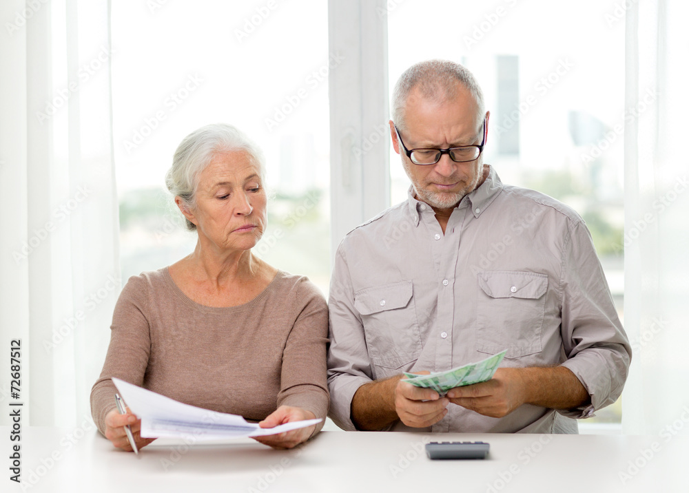 Canvas Prints senior couple with money and calculator at home