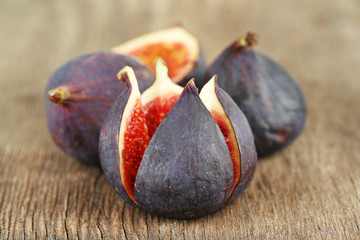 Ripe sweet figs on wooden background