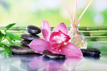 Spa stones, sticks, bamboo branches and lilac orchid