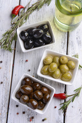 Different marinated olives on table close-up