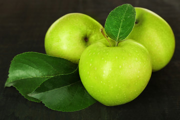 Ripe green apples on wooden background