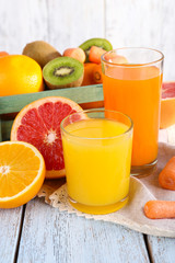 Fruit and vegetable juice in glasses and fresh fruits in box