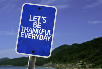 Let's Be Thankful Everyday sign with a beach on background