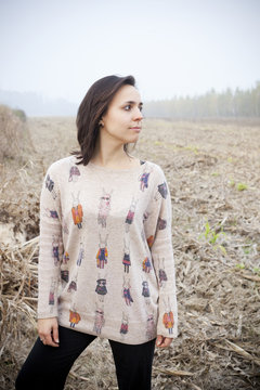 brunette girl looking the horizon in the countryside