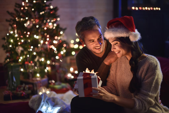 portrait of a young couple in their living room in  christmas ev