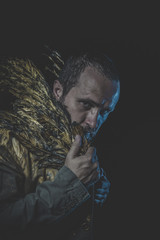 Sexy Fallen angel, man beard and suit made with golden wings