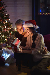 portrait of a young couple in their living room at christmas eve