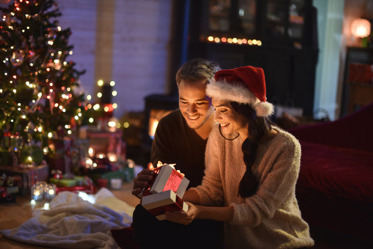 portrait of a young couple in their living room at christmas eve