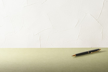 Desk. Office supply on Desk.Empty Wall of Stucco.