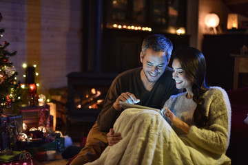 Handsome couple in their decorated living room at  christmas eve
