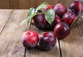 Sweet plums on wooden background