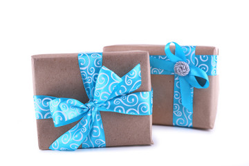 Holiday gift boxes decorated with blue ribbon isolated on white
