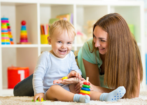 happy mother and child son play together indoor at home