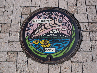 Manhole drain cover on the street at Kawaguchiko lake, Japan