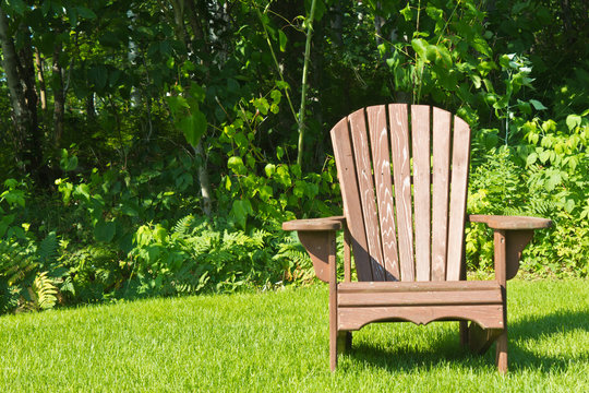 Adirondack summer lawn chair outside on the green grass