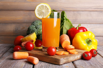 Carrot juice in glass and fresh vegetables