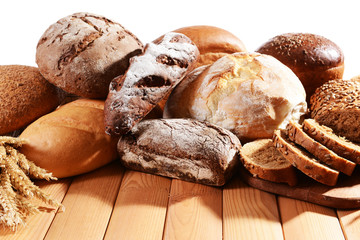 Fresh bread on table on white background