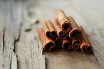 Cinnamon on wooden background, close-up