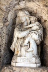 Fototapeta na wymiar Madonna with Child, sculpture on a Mirogoj cemetery in Zagreb