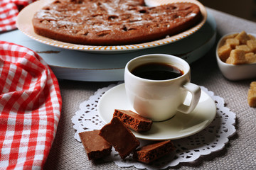 Homemade chocolate pie and cup of coffee on table
