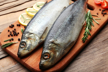 Fresh raw fish and food ingredients on table