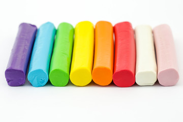 Colorful rod plasticine arranging on white background