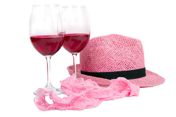 two glasses of red wine on a white background near pink panties