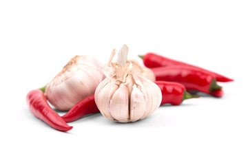 Chile peppers and garlic on a white background with a drop shado