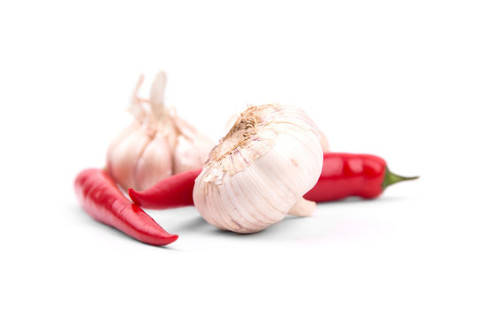 Chile peppers and garlic on a white background with a drop shado