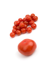 Big tomato on the background of small cherry