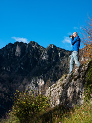 Naklejka na ściany i meble Photographer in the mountains