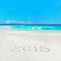 Fototapeta na wymiar Happy New Year 2015 season concept on tropical sandy beach