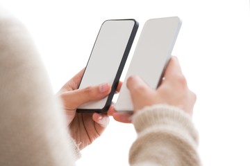 Close up of woman holding smartphones