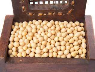 Soybean in wooden box over white background