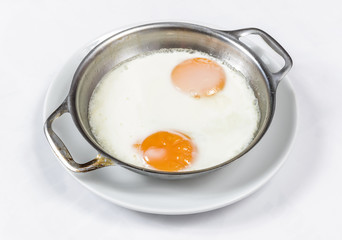 Fried eggs on the skillet