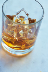 whiskey with ice on a table