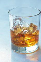 whiskey with ice on a table